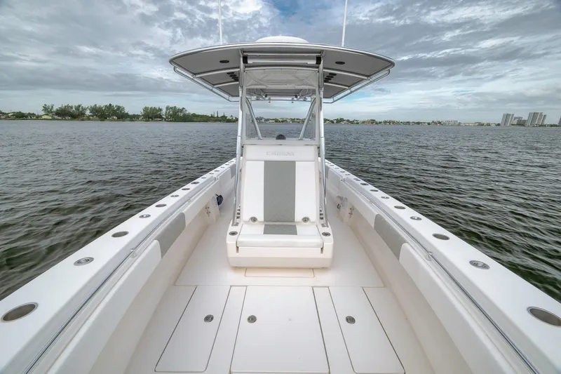 Slide: The Image of 2012 Contender 32 Tournament boat on open water, showcasing sleek design and spacious deck. - 49