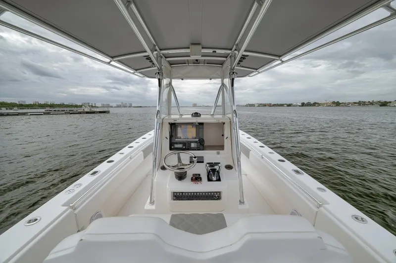 Slide: The Image of 2012 Contender 32 Tournament boat interior with steering console on open water. - 52