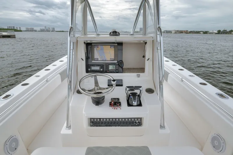 Slide: The Image of 2012 Contender 32 Tournament boat helm with navigation equipment on calm waters. - 53