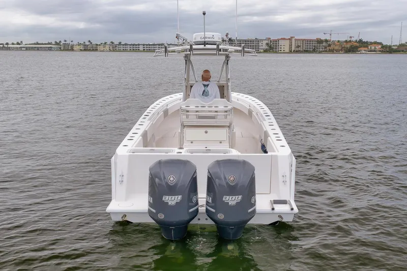 Slide: The Image of 2012 Contender 32 Tournament boat with dual Yamaha engines on calm water. - 6