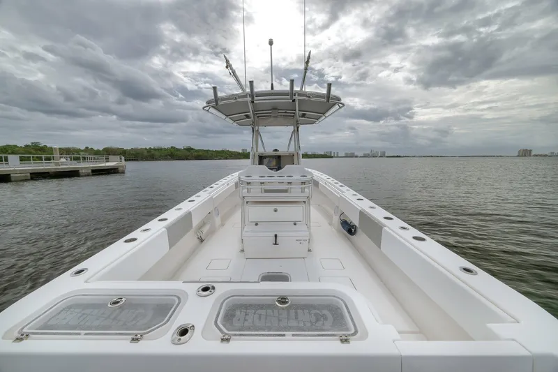 Slide: The Image of 2012 Contender 32 Tournament boat on calm water under cloudy sky. - 61