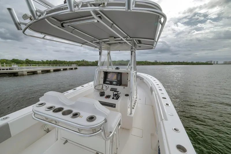 Slide: The Image of 2012 Contender 32 Tournament boat on calm water, featuring a sleek console and seating. - 62