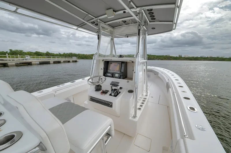 Slide: The Image of 2012 Contender 32 Tournament boat interior with helm, steering wheel, and navigation system. - 64
