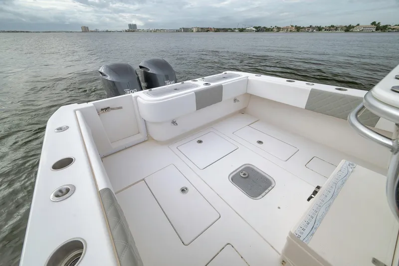 Slide: The Image of 2012 Contender 32 Tournament boat deck with dual engines on calm water. - 65