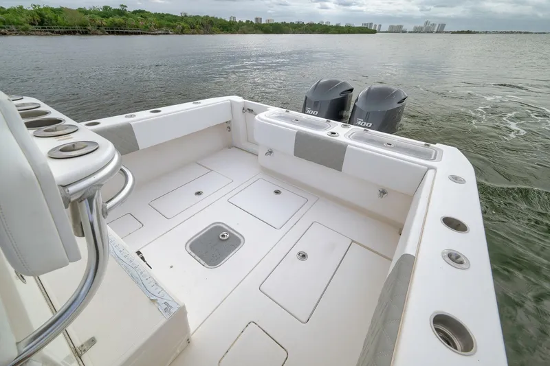 Slide: The Image of 2012 Contender 32 Tournament boat deck with dual engines on calm water. - 66