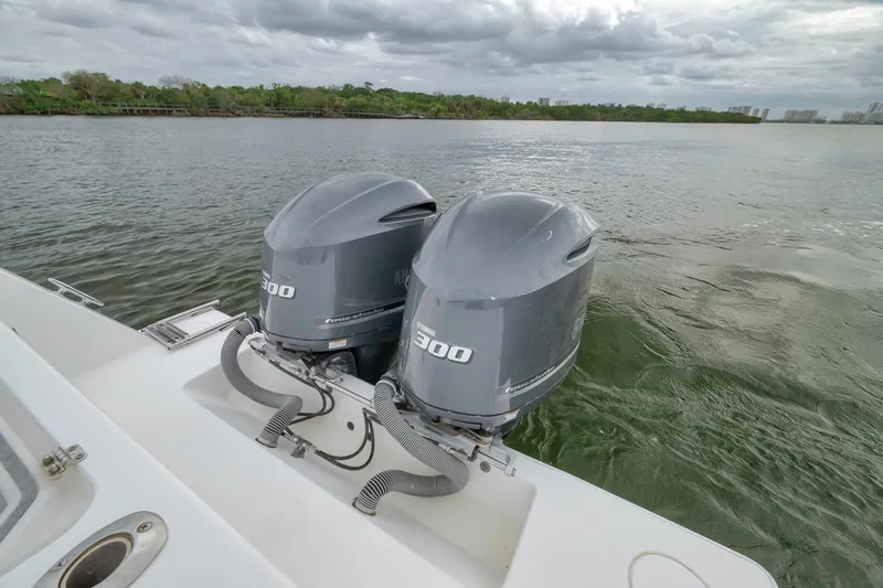 Slide: The Image of 2012 Contender 32 Tournament boat with twin 300 horsepower engines on a calm waterway. - 67