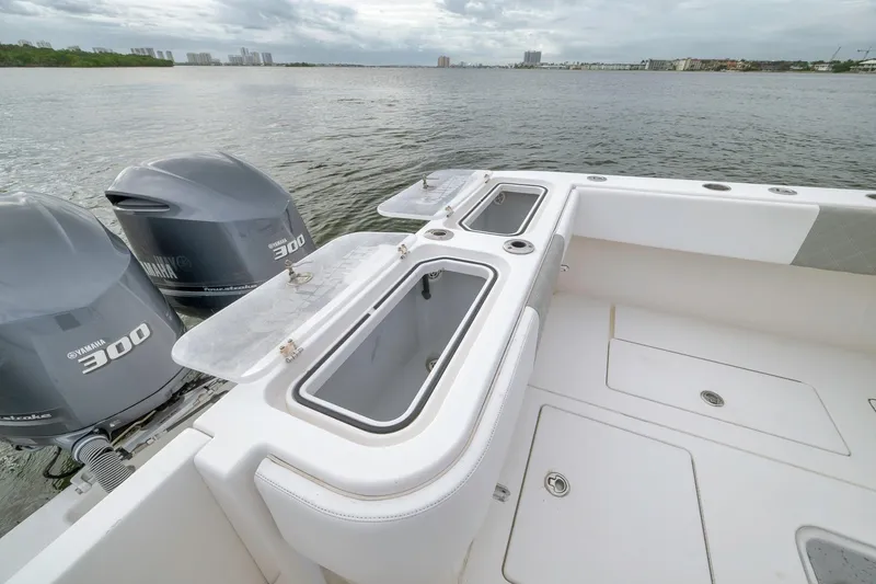 Slide: The Image of 2012 Contender 32 Tournament boat with Yamaha 300 engines on a calm water backdrop. - 68