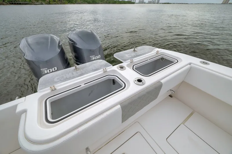 Slide: The Image of 2012 Contender 32 Tournament boat with dual Yamaha 300 engines on calm water. - 69