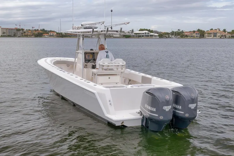 Slide: The Image of 2012 Contender 32 Tournament boat with dual Yamaha engines on calm water. - 7