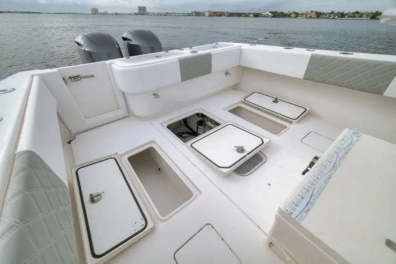 Slide: The Image of 2012 Contender 32 Tournament boat deck with storage compartments, ocean view in background. - 71