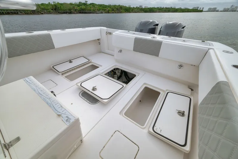 Slide: The Image of 2012 Contender 32 Tournament boat deck with storage compartments and dual engines. - 72