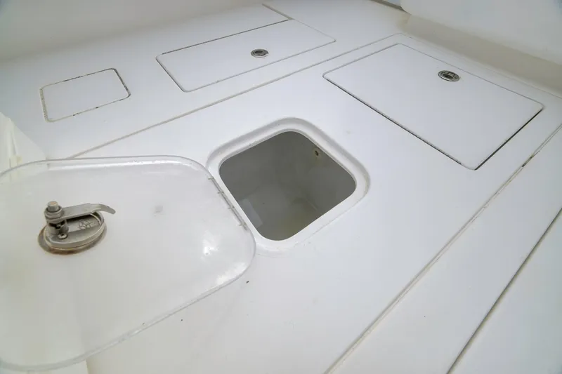 Slide: The Image of 2012 Contender 32 Tournament boat storage compartments with open hatch. - 74