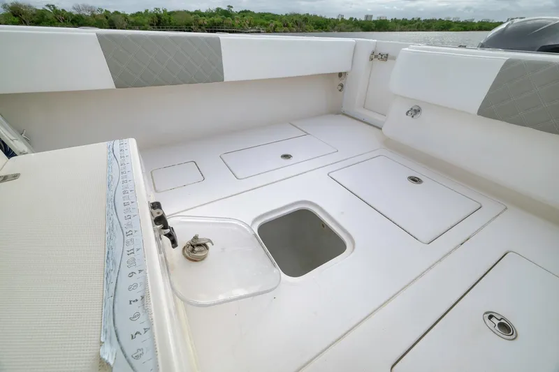 Slide: The Image of 2012 Contender 32 Tournament boat deck with storage compartments and seating. - 75