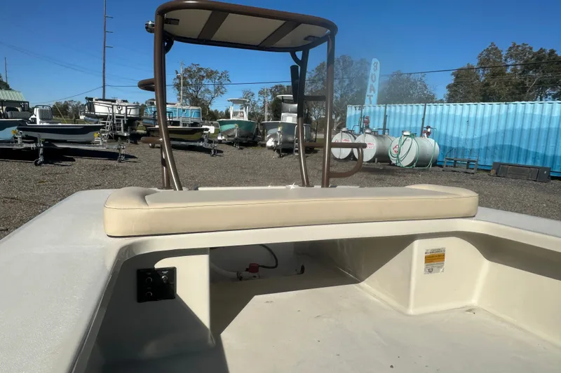 Slide: The Image of 2026 Delta Boatworks Delta D18 with rod holders, displayed outdoors among other boats. - 11