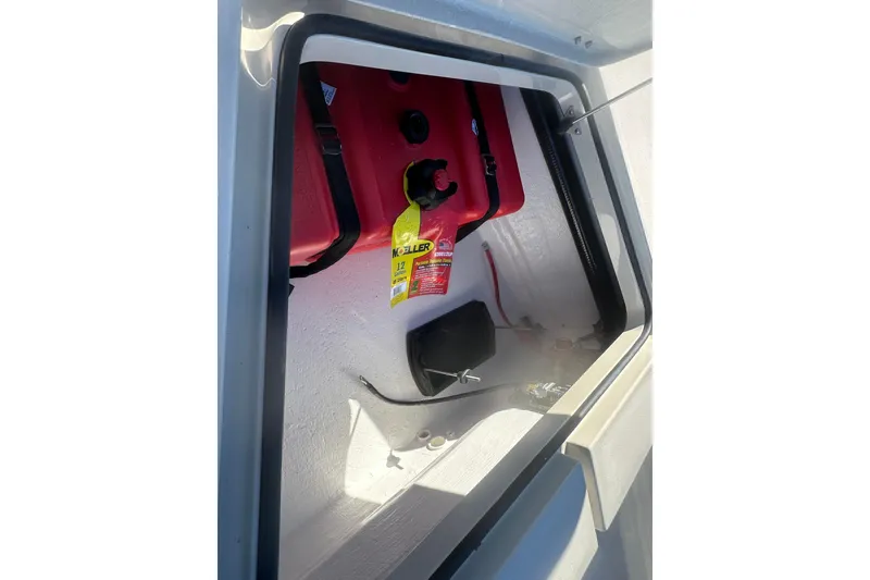 Slide: The Image of Open storage compartment in 2026 Delta Boatworks Delta D18, featuring a red fuel tank. - 15