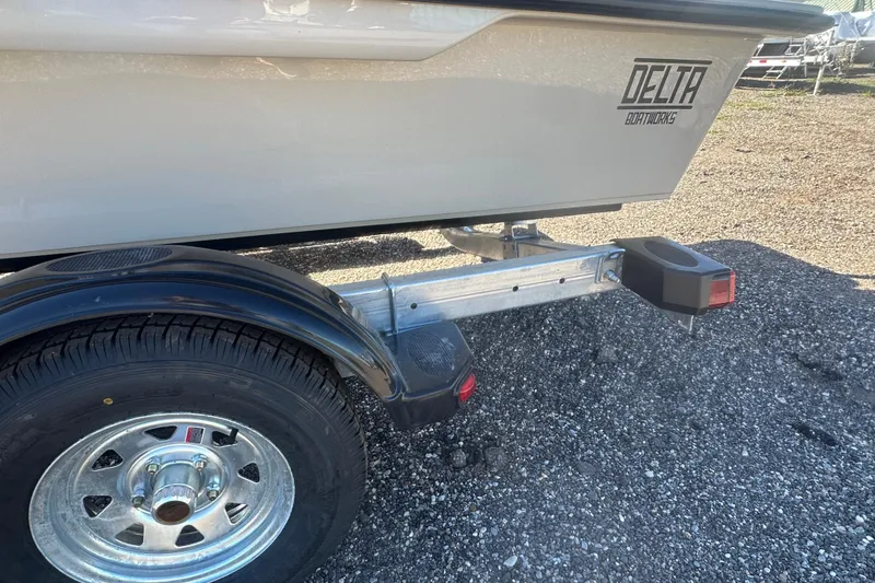 Slide: The Image of 2026 Delta Boatworks Delta D18 on trailer, parked outdoors near a rustic building. - 17