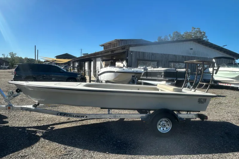 Slide: The Image of Outboard motor on Delta D18 boat, 2026 model, in a sunny outdoor setting. - 6
