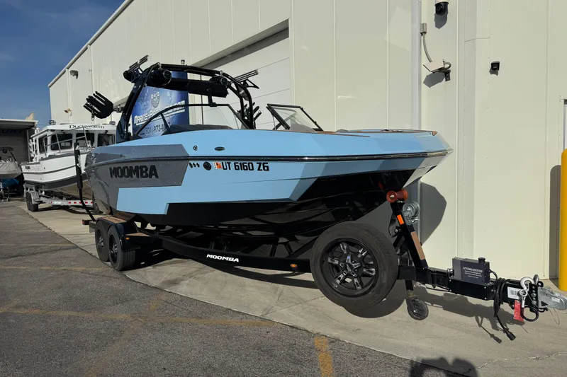 Slide: The Image of 2024 Moomba Tykon boat on trailer, parked outside a building. - 3
