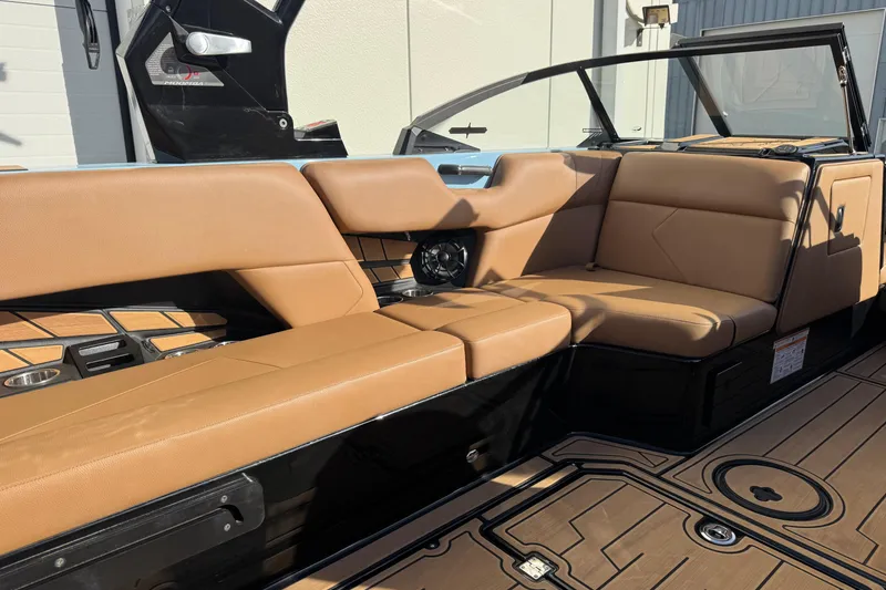 Slide: The Image of 2024 Moomba Tykon boat interior with tan leather seating and modern design. - 9
