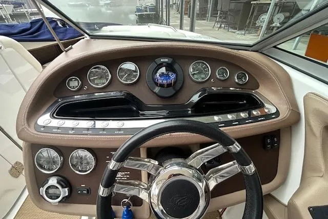 Slide: The Image of Dashboard of a 2014 Cobalt 302 boat with gauges and steering wheel. - 15
