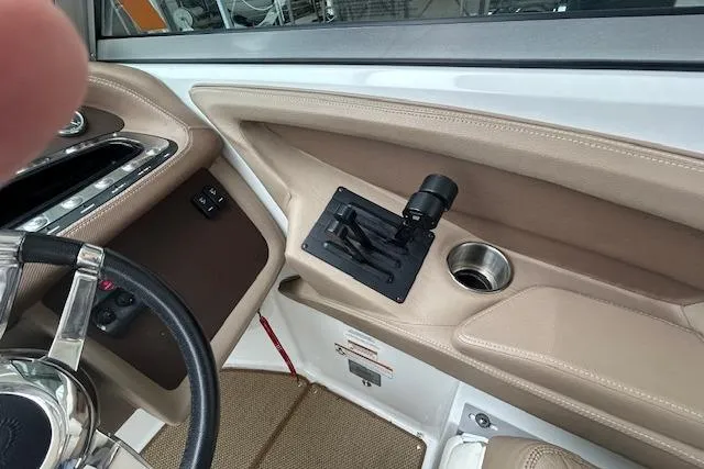 Slide: The Image of Interior of a 2014 Cobalt 302 boat, featuring steering wheel and control panel. - 16