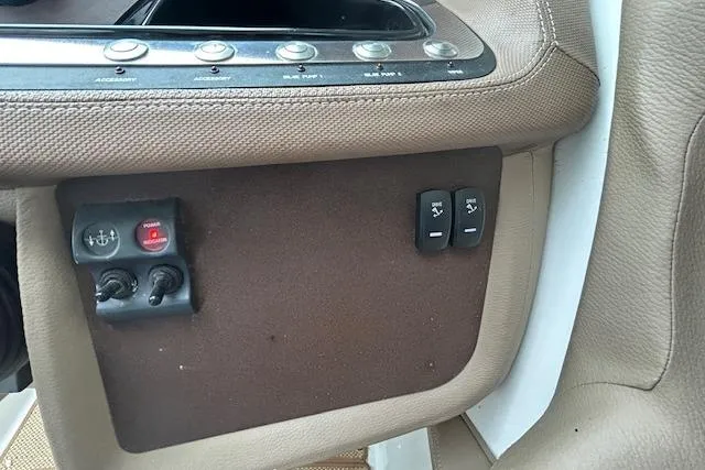 Slide: The Image of 2014 Cobalt 302 boat interior controls with brown and beige upholstery. - 17