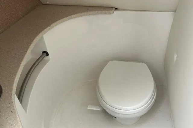Slide: The Image of Compact bathroom in 2014 Cobalt 302 boat with white toilet and countertop. - 20