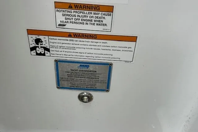 Slide: The Image of Warning labels and yacht certification on a 2014 Cobalt 302 boat. - 21
