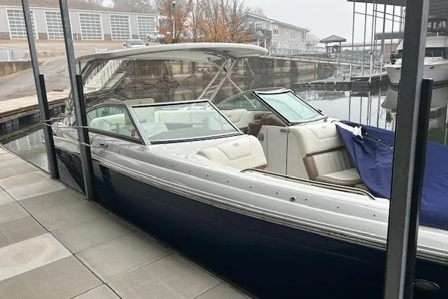 Slide: The Image of 2014 Cobalt 302 boat docked at a marina with covered seating area. - 25