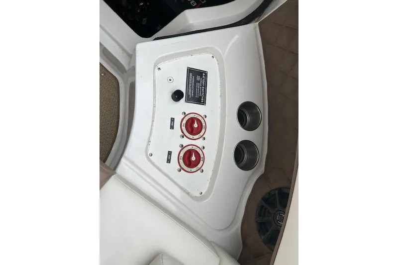 Slide: The Image of Control panel of a 2014 Cobalt 302 boat with switches and cup holders. - 9