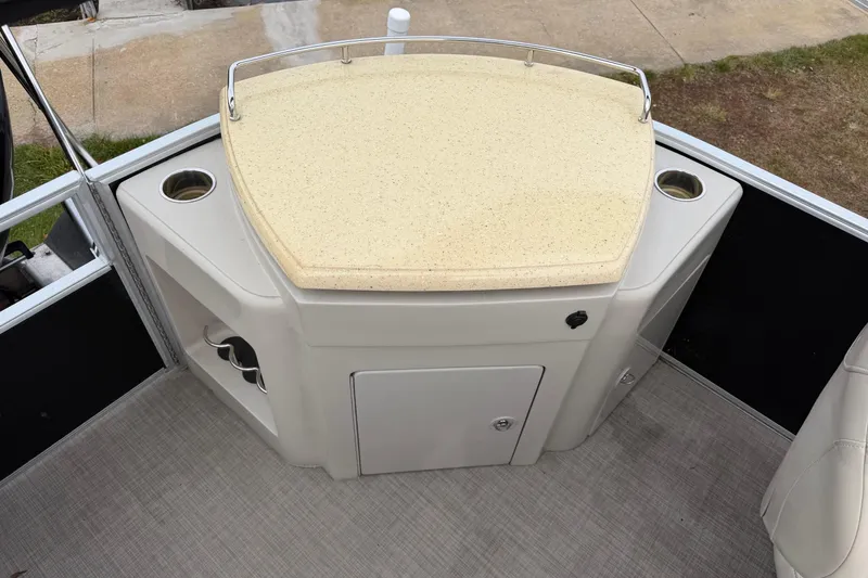 Slide: The Image of 2016 Bennington SXP 24 SSBXP boat interior with beige countertop and cup holders. - 4