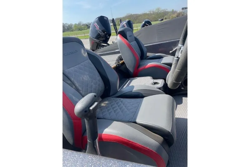 Slide: The Image of 2022 Caymas CX19 boat interior with gray and red seats, steering wheel, and motor in background. - 4