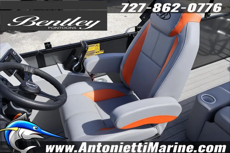 Slide: The Image of 2026 Bentley Pontoons Legacy 203 Swingback captain's chair with orange accents and steering wheel. - 11