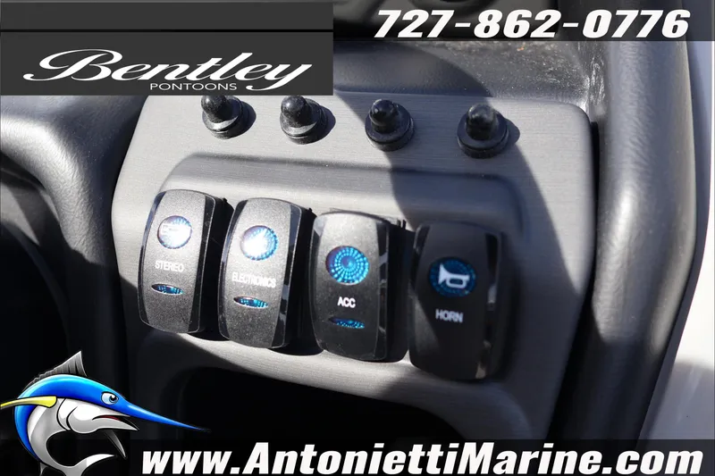 Slide: The Image of Control panel of 2026 Bentley Pontoons Legacy 203 Swingback with switches for stereo, electronics, and horn. - 13