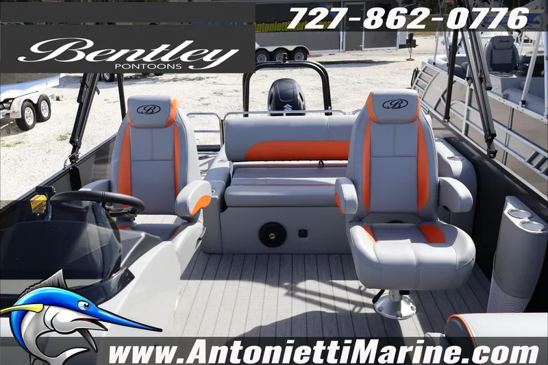 Slide: The Image of 2026 Bentley Pontoons Legacy 203 Swingback interior with gray and orange seating, Antonietti Marine branding. - 16