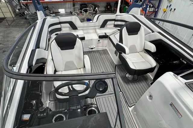 Slide: The Image of 2020 Yamaha Boats 242SE interior with sleek seating and modern dashboard design. - 13