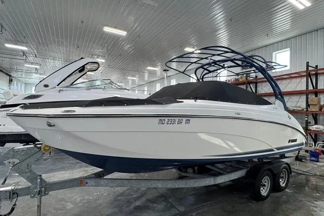 Slide: The Image of 2020 Yamaha Boats 242SE in a showroom, sleek design, on a trailer. - 3