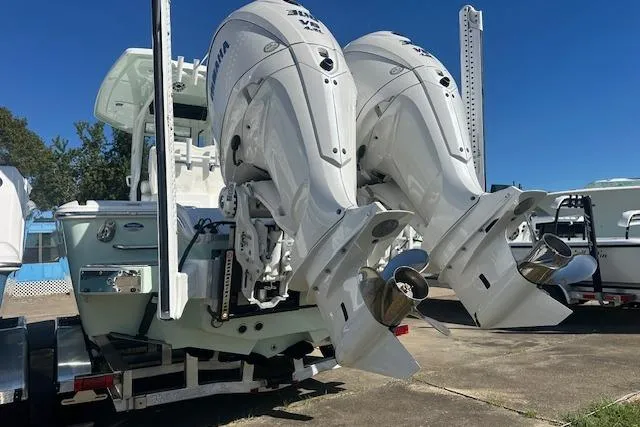 Slide: The Image of 2026 Tidewater 2700 Carolina Bay boat with dual outboard engines on a trailer. - 3