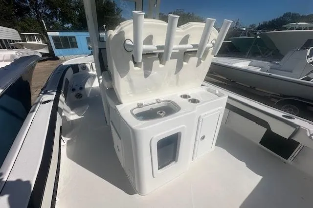 Slide: The Image of 2026 Tidewater 2700 Carolina Bay boat with fishing rod holders and sink station. - 7