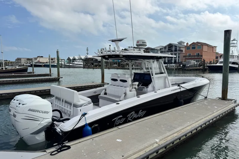 Slide: The Image of 2018 Fountain 34 Center Console boat docked at marina with Mercury engines. - 0