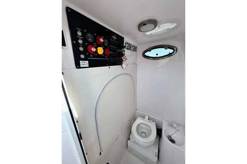 Slide: The Image of Interior of 2018 Fountain 34 Center Console boat with control panel and marine toilet. - 10