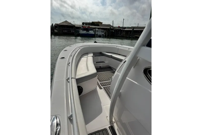 Slide: The Image of 2018 Fountain 34 Center Console boat interior with seating and deck view. - 16