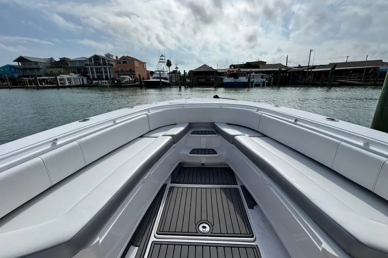 Slide: The Image of 2018 Fountain 34 Center Console boat docked, featuring spacious seating and sleek design. - 17