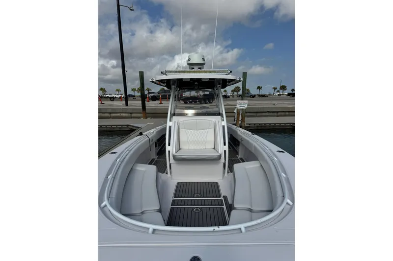 Slide: The Image of 2018 Fountain 34 Center Console boat docked, featuring sleek seating and modern design. - 19
