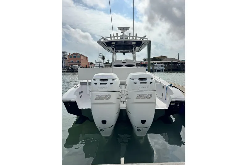 Slide: The Image of 2018 Fountain 34 Center Console boat with twin 350 engines docked in marina. - 2