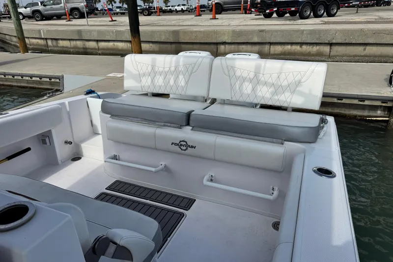 Slide: The Image of 2018 Fountain 34 Center Console boat interior with white seating at dock. - 22