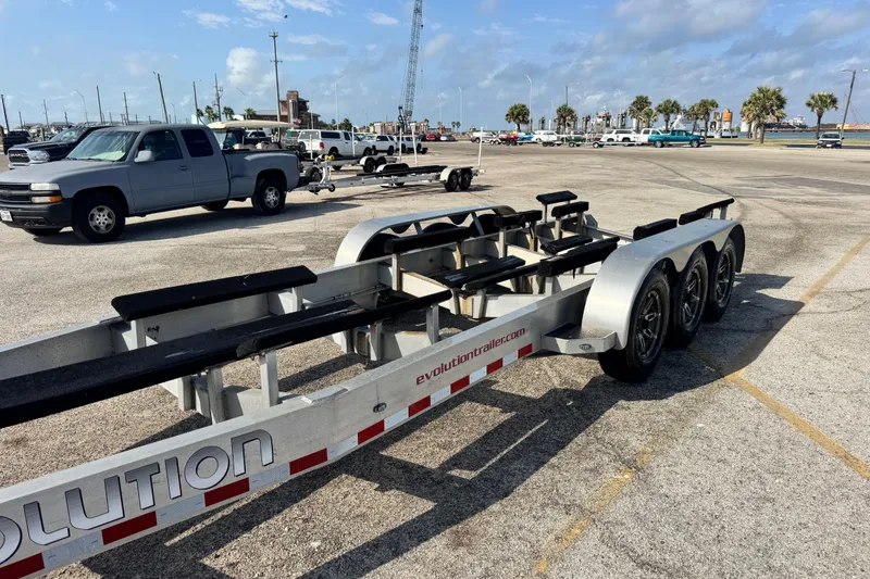 Slide: The Image of Trailer for 2018 Fountain 34 Center Console boat in parking lot with trucks. - 25