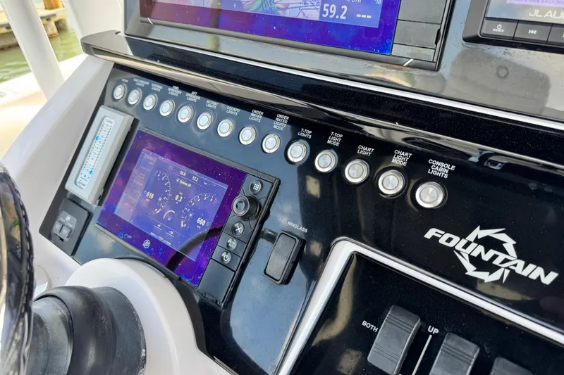 Slide: The Image of Control panel of a 2018 Fountain 34 Center Console boat with digital displays and switches. - 6