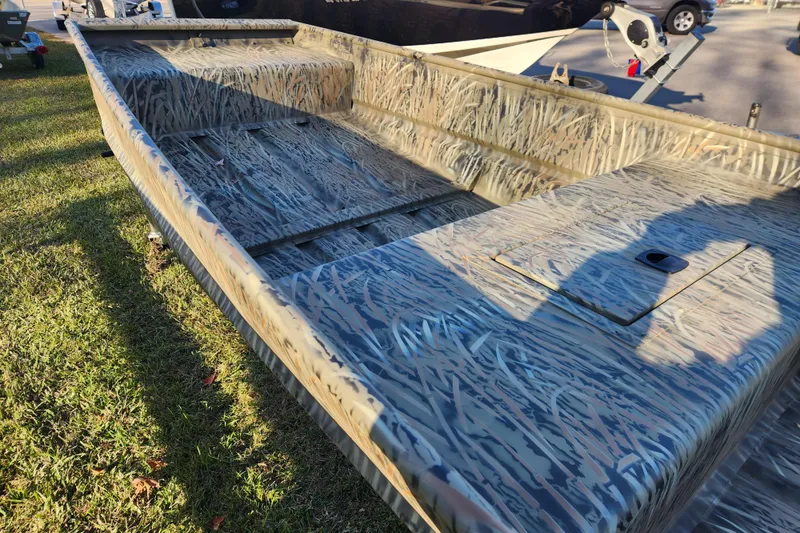 Slide: The Image of 2026 Tracker Grizzly 15 Jon boat with camouflage design on grass. - 3