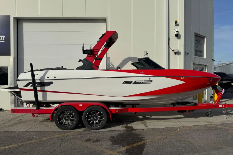 The Image of 2020 MB B52 23 Classic boat on red trailer, parked outside a building. - 0